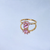 Gold paw ring with pink gemstone