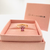Gold paw ring with pink gemstone in jewelry box
