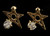 Gold tone cubic zirconia stud earrings with metal star design and stone faceted to the bottom, left point of the star CZ03