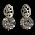 Silver tone cubic zirconia stud earrings with a circle shaped stone beneath an oval shaped metal design CZ14A