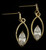 Gold tone cubic zirconia dangle earrings with a pointed oval shaped stone within a larger pointed oval CZ24