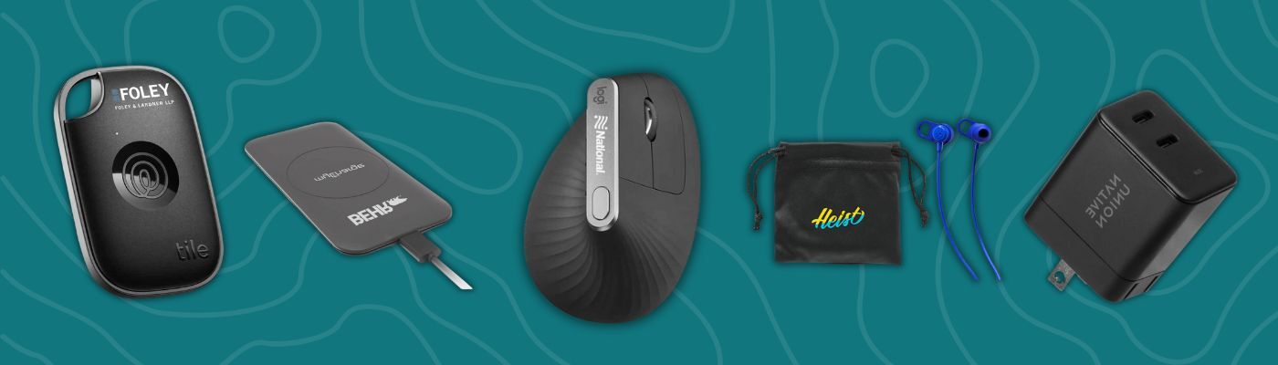Tech promotional giveaways featuring Tile tracker, MyCharge wireless pad, Logitech ergonomic mouse, Skullcandy earbuds, and Native Union charger.
