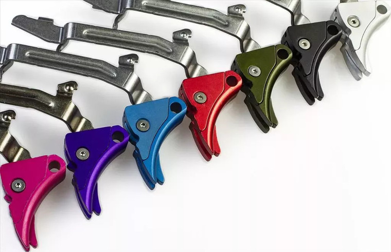 Lone Wolf adjustable triggers in multiple colors lined up on a white background.