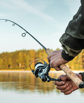 An ice fisher coming out of her tent.