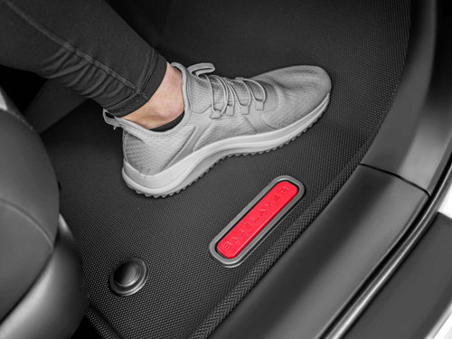 BaseLayer Custom-Fit All-Weather Floor Liners for the Toyota Tacoma 2016 - 2023 Access Cab and Double Cab. Front passenger side with foot in senaker.