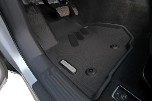 BaseLayer custom-fit floor liners front and rear set for the 2025 Toyota Tacoma Double Cab with gray logo - front driver side installed