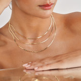Multi-Strand Gold Herringbone Necklace on Brown Skin Model