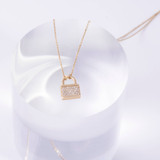 The padlock pendant is adorned with dazzling diamonds, adding elegance and allure.