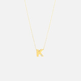 14k diamond initial necklace. Fine cable chain with solid gold letter pendant and bezel set white diamond.