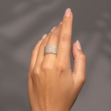 10k Gold 6-Row Pave Diamond Band en la mano de un modelo: Con una amplia silueta de anillo de cigarro.