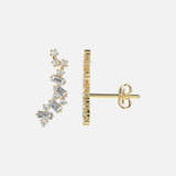 A Diamond Ear Crawler Earrings crafted in shiny 18k gold, each ear crawler strikes a beautiful balance between baguette and round cut diamonds.