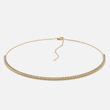 A diamond tennis chain necklace, which is cast in sleek and shiny yellow gold.