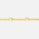 This stunning gold chain choker showcases a handcrafted, shiny 14k gold curb chain silhouette with bold station cube charms, making it an appealing year-round piece.