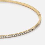 A close up of a 14k gold Flexible Diamond Bracelet, a captivating piece featuring 1 ct of brilliant cut diamonds.
