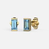 Crafted from 14k gold, the Blue Topaz Stud Earrings are both elegant and edgy, featuring centered, lustrous baguette blue topaz measuring 3 x 5mm.