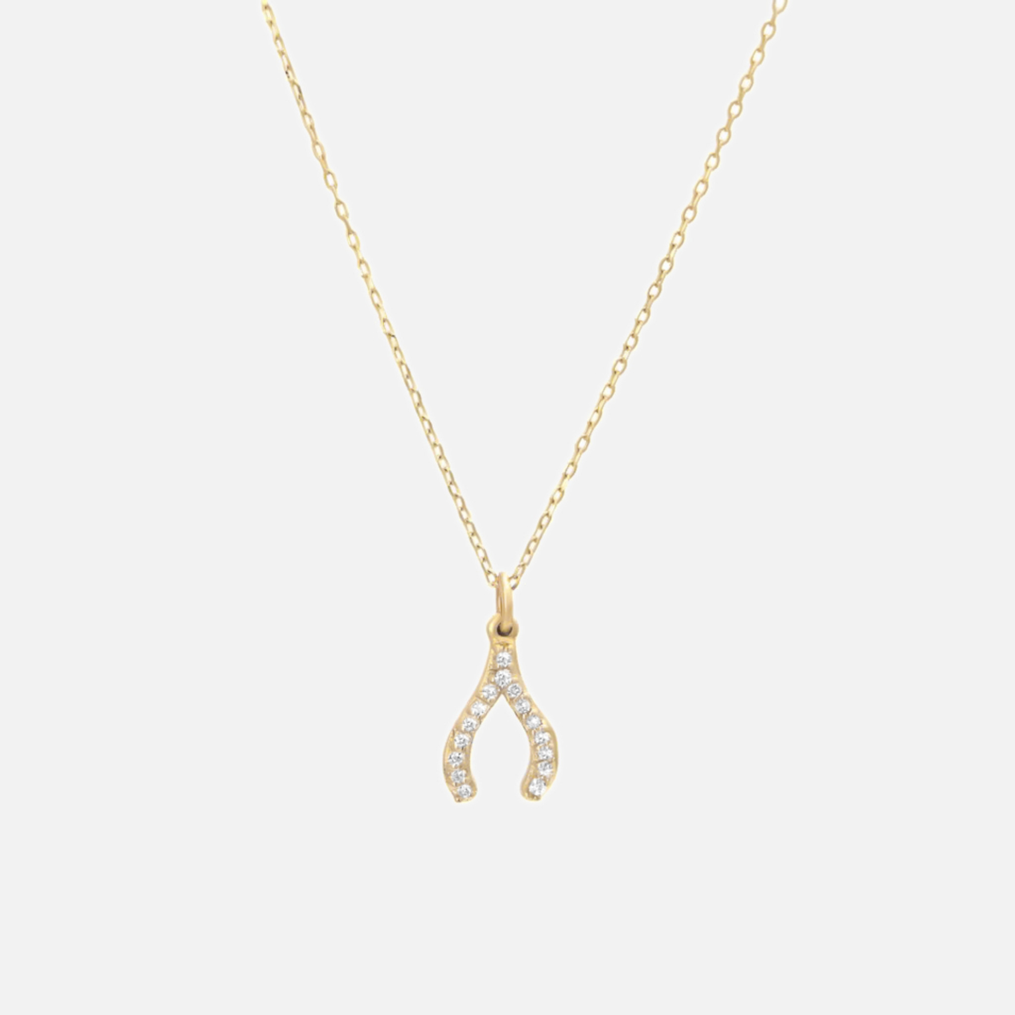 Shiny 14k gold diamond wishbone necklace. Delicate cable chain with single-prong pave diamond lucky bone pendant.