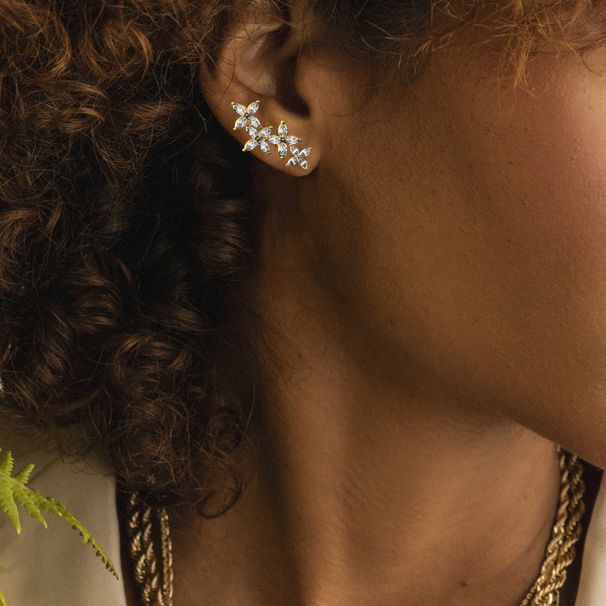 Adorning elegance on a dark-skinned model, our Diamond Ear Crawler Earring stacking with our Diamond Star Stud Earring to create a unique style.