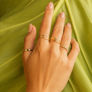 Criss cross Ring on Clear Skin Model Hand: Strong solo statement, or paired with thin gold rings for a dynamic layered look, this crisscross ring delivers.