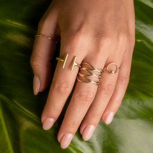 Thin Gold Band Ring on Clear Skin Model Hand: Add this stacker thin gold band ring to your collection for the perfect extra shimmer.