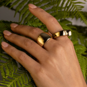 Gold Dome Ring on Clear Skin Model Hand: This Ring can be worn alone or paired with other stacking rings to elevate your style game.