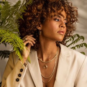 Crescent Moon Necklace on Brown Skin Model: Catch the light with the crescent moon necklace, wear solo or elevate chunky silhouettes.