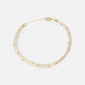 Meticulously crafted from 14k gold, this bracelet features delicate bezel set diamonds that beautifully accentuate its design.