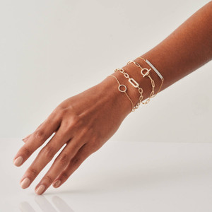 In 14k gold, this double diamond bar bracelet features twin diamond-studded bars on a slim cable chain, adjustable for your comfort, and is perfect alone or layered with other fine chain bracelets, elegantly gracing a Puerto Rican model's hand.