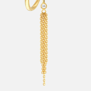 Close-up of a single gold tassel earring, highlighting its delicate design and chain accents.