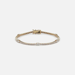 Elevate your wrist game with the Yellow Gold Tennis Bracelet, a sleek piece with 60 to 74 diamonds (2 to 4 ct) in a classic continuous silhouette, secured with a stylish box lock clasp.