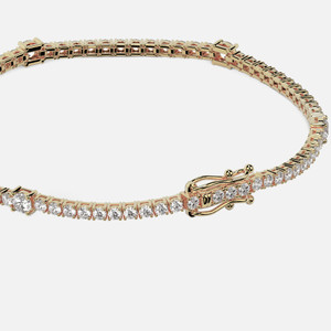 Crafted with precision, this yellow gold tennis bracelet features 60 to 74 brilliant-cut diamonds (2-4 ct) and a dependable box lock clasp for a touch of elegance.