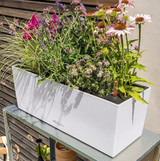 White Balconera Planter with white, pink and purple flowers on a table