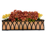 Arch Railing Planter, a decorative rectangular planter with a black metal arch design filled with pink and yellow flowers.