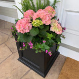 Prestige Square Planter, black square decorative planter filled with pink and green flowering plants and lush green foliage.