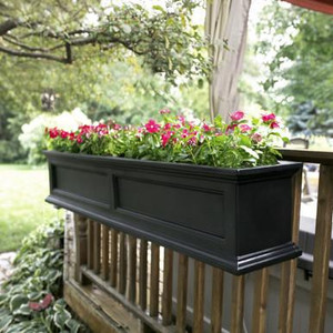 Prestige Railing Planter, black rectangular floral planter filled with pink and white flowers mounted on a wooden balcony railing.