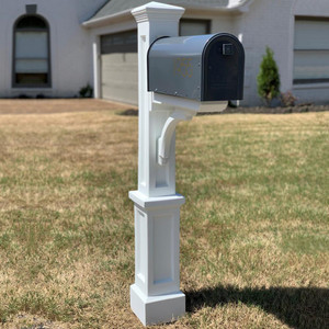 Presidential Mail Post, a classic mailbox on a decorative white stand in front of a suburban house. Presidential Mail Post, a classic mailbox on a decorative white stand in front of a suburban house.