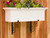 White Window Box mounted on wood fence using Scroll Shelf Brackets