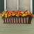 Venetian window box with copper liner mounted to house with orange and yellow flowers