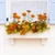 White Laguna Window Box with faux brackets mounted under a window with fall flowers