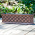 La Fleur fiberglass window box coated with liquid copper on wood deck
