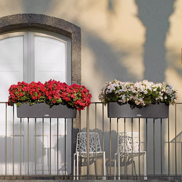 2 Granite Cottage Weave window boxes on a railing, on left is planted with red flowers, on right is planted with white flowers.