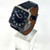 Hermès Carré H 38mm automatic watch, black dial and leather strap, angled view