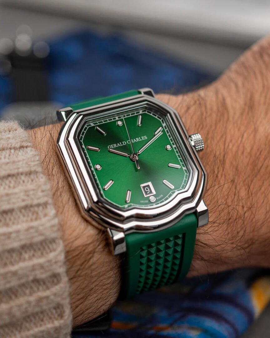Gerald Charles Maestro 2.0 Ultra-Thin with an emerald green dial worn on a man's wrist below a cream knit sleeve, seen from above.