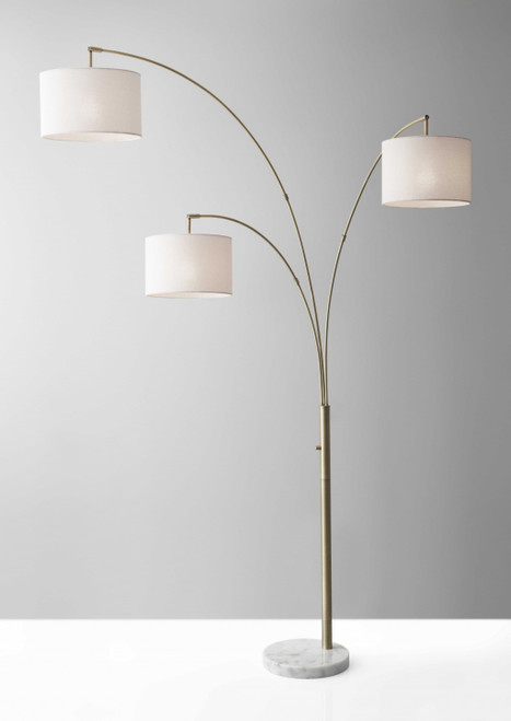 74" Brass Three Light Arc Floor Lamp With Off White Fabric Drum Shade