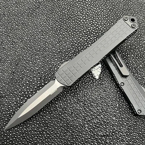 Automatic opening. 3.88" (9.86cm) closed. 2.63" (6.68cm) two-tone finish double edge CPM MagnaCut stainless dagger blade. Black aluminum handle. Glass breaker. Lanyard hole. Pocket clip. Frag pattern handle. Boxed.