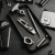 display of Toor Knives EDC collection featuring Thor's Hammer push dagger, multi-tool with bottle opener, precision screwdriver, and accessories arranged in black tray alongside leather holster and smartphone on textured surface