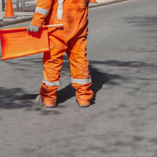 Man being a spotter on a road.