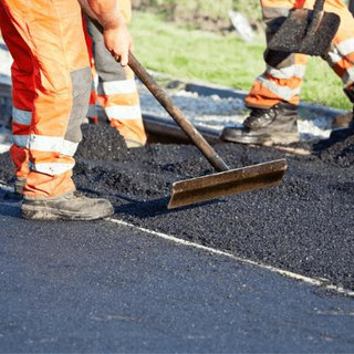 Workers applying asphalt