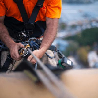 Man using rope access by harness.