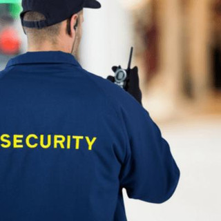 Security guard holding walkie talkie