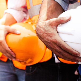 Engineer team holding hardhat standing in row ready for work